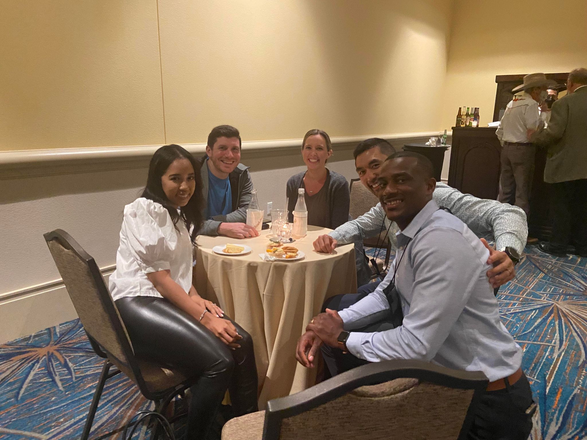 50th AAO event attendees posed at table March 25, 2022.