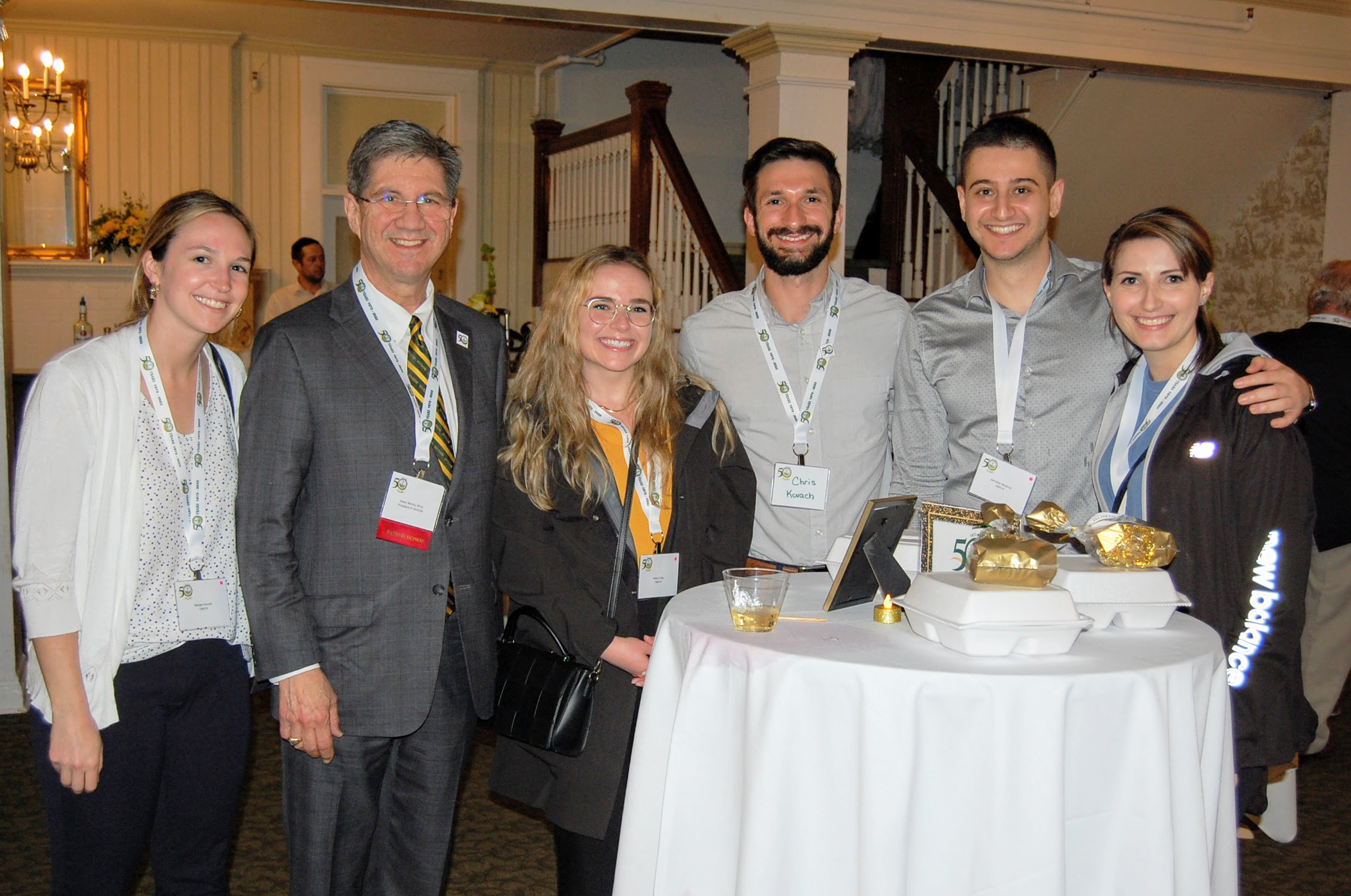 Dr. Nemitz posed with 5 attendees smiling for camera 