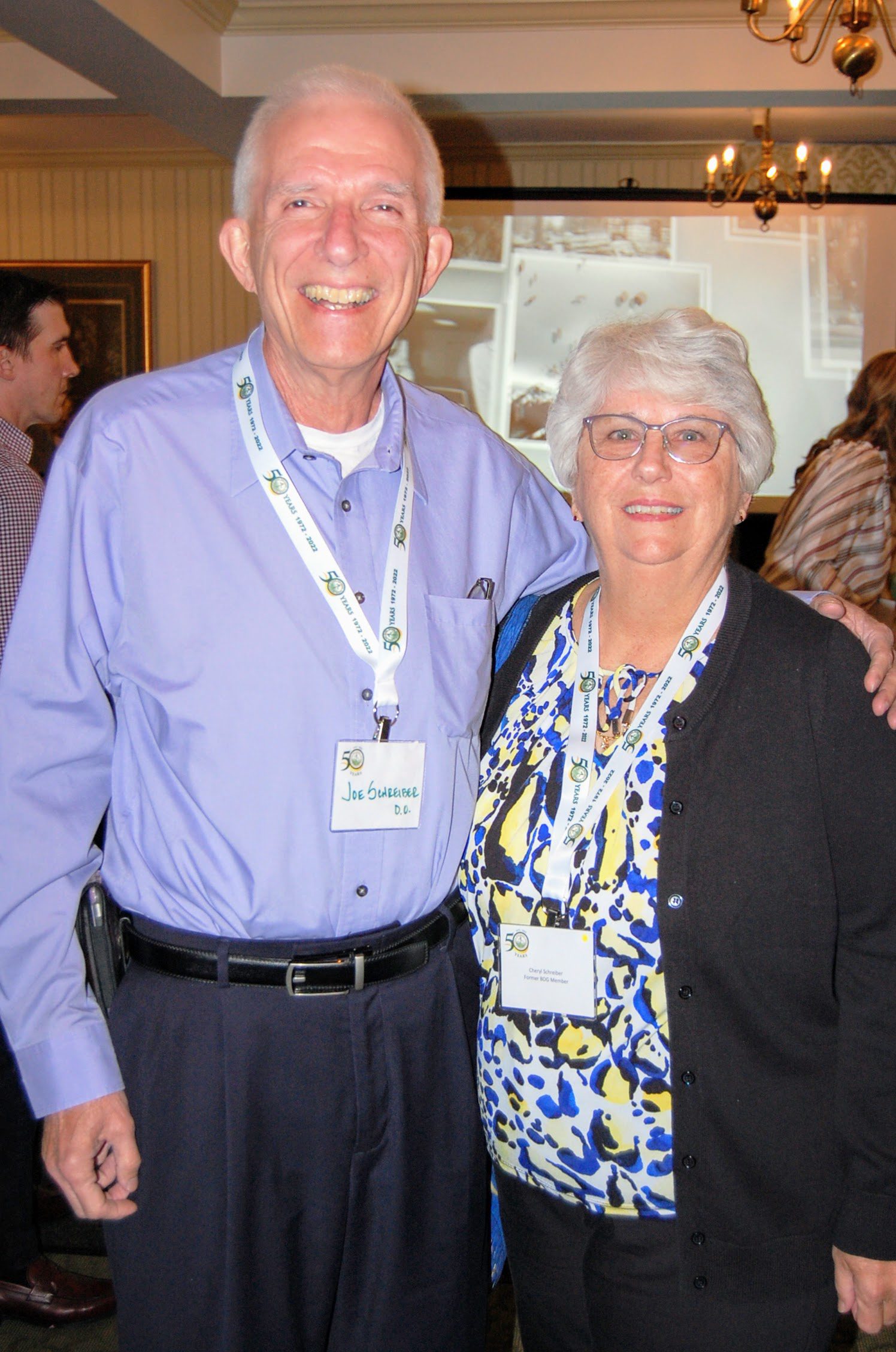 Joe and Cheryl Schreiber stand together smiling for camera