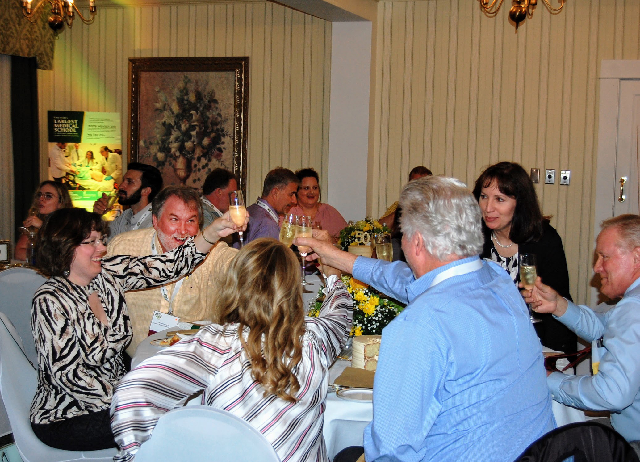 Table of attendees gives champagne toast at event