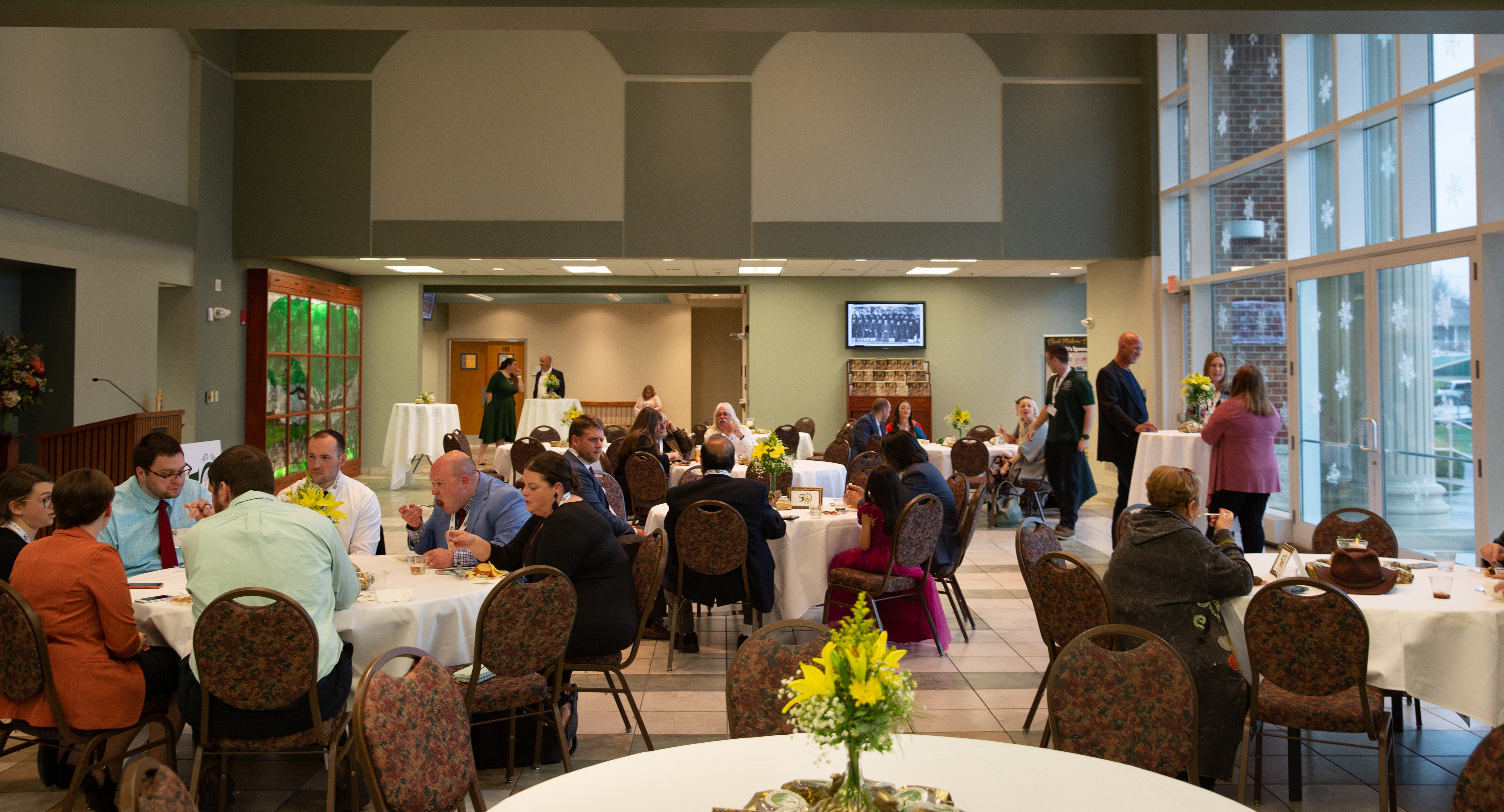 Event photo of attendees gathered at tables