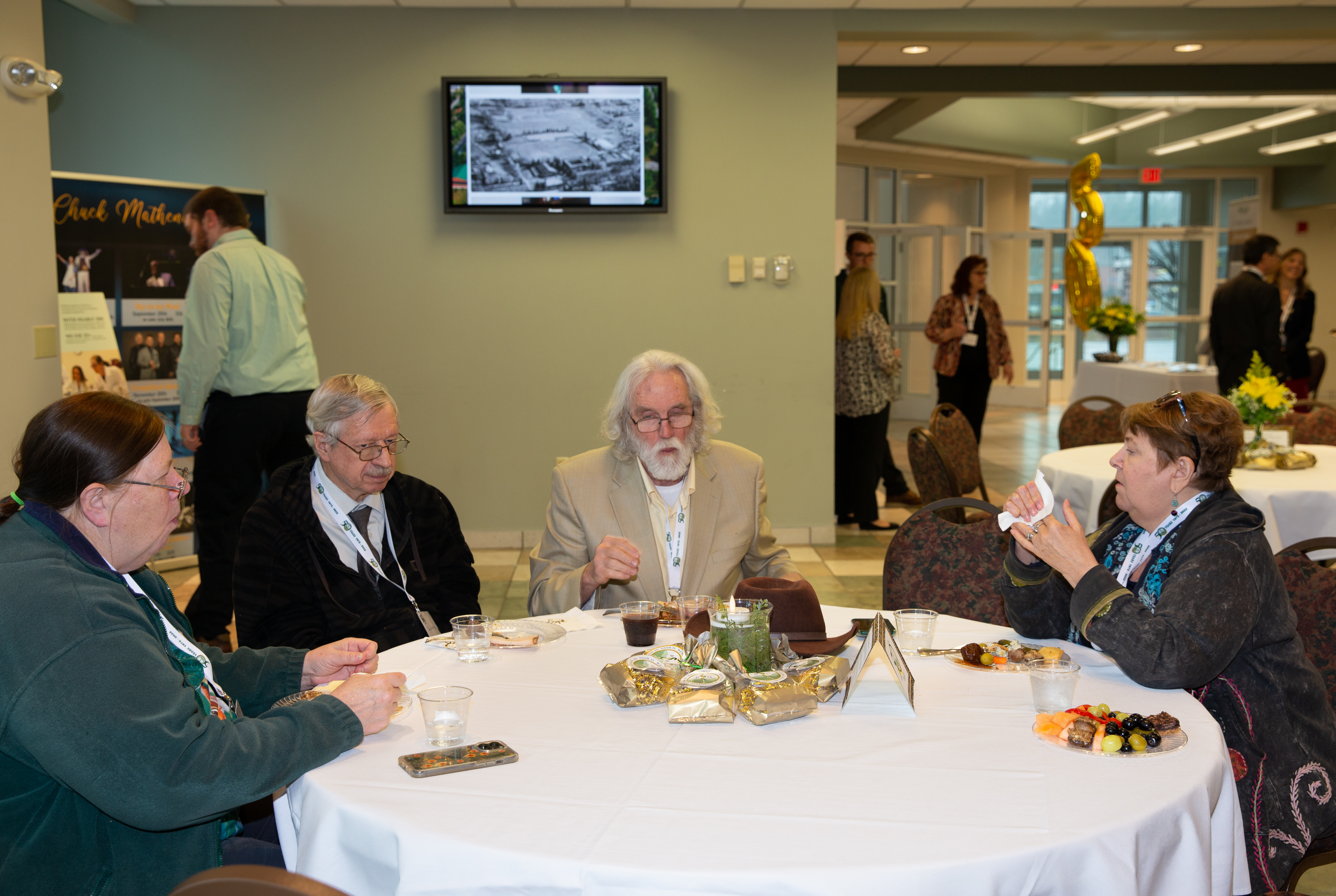 SWC attendees seated at table enjoying hors d'oeuvres