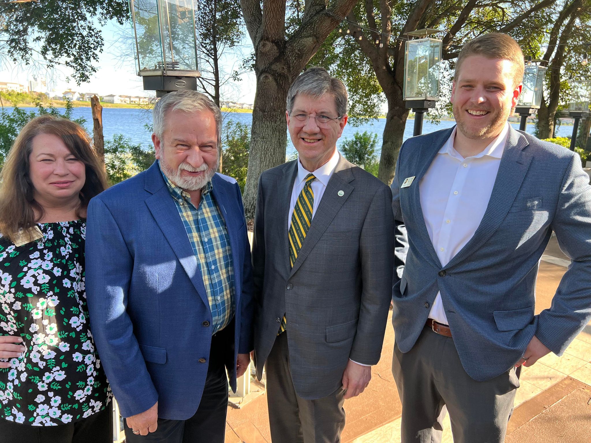 Dr. Nemitz and Dr. Holstein with WVSOM foundation and Alumni Associate department heads at event outside.