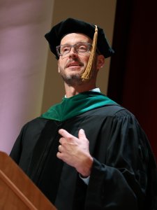 Ryan Newell, D.O., speaking from behind a lectern.