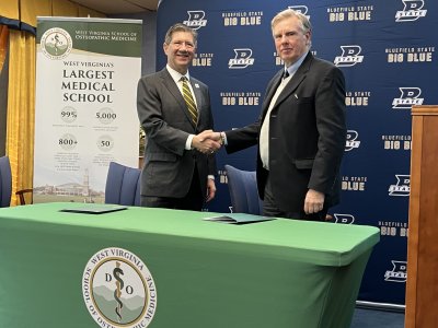 WVSOM President James W. Nemitz, Ph.D., and Bluefield State University President Robin Capehart shake hands.