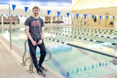Matt Dyer stands next to a swimming pool
