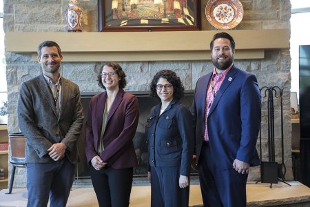 Four individuals standing in WVSOM's President's Parlor