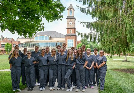 A group of students standing on WVSOM's campus