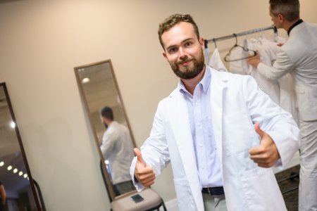 First-year WVSOM student tries on white coat.
