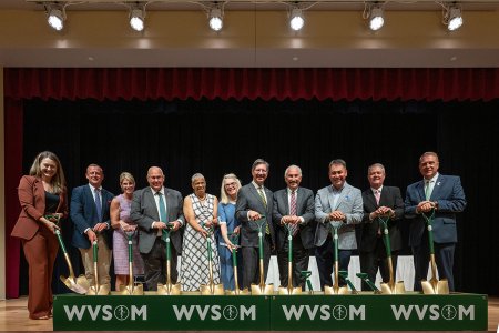 Government officials stand with shovels at ceremonial groundbreaking