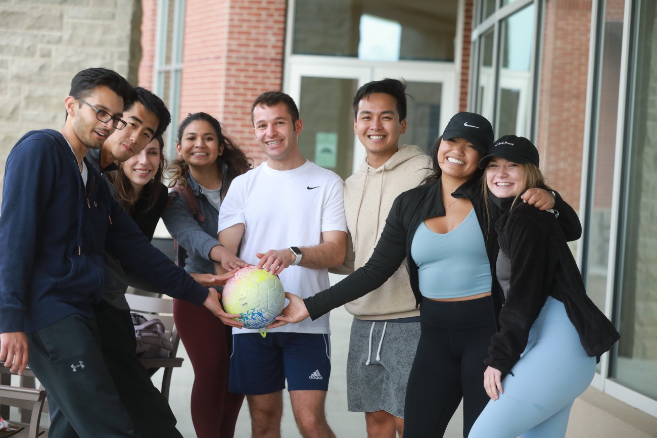 Students hanging out and having fun in front of the student center