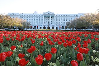 Greenbrier front entrance plus red flowers