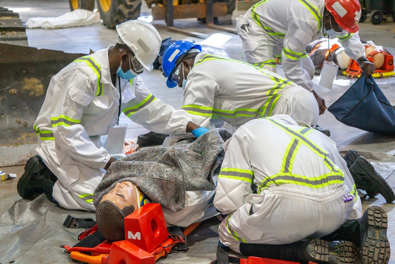 A mining team from Zambia works with a human-patient simulator WVSOM provided for use in a mine rescue first aid competition.