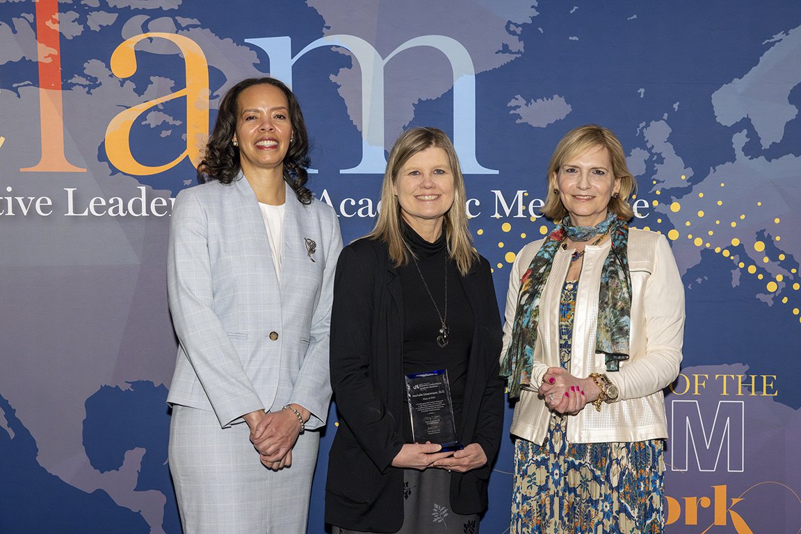 Machelle Linsenmeyer, Ed.D., stands in the center, between the ELAM program's directors